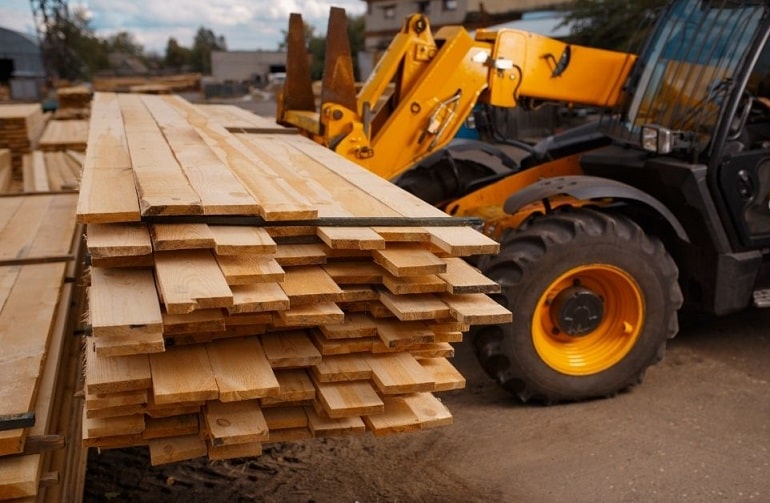 Forklift Loads the Boards in the Lumber Yard